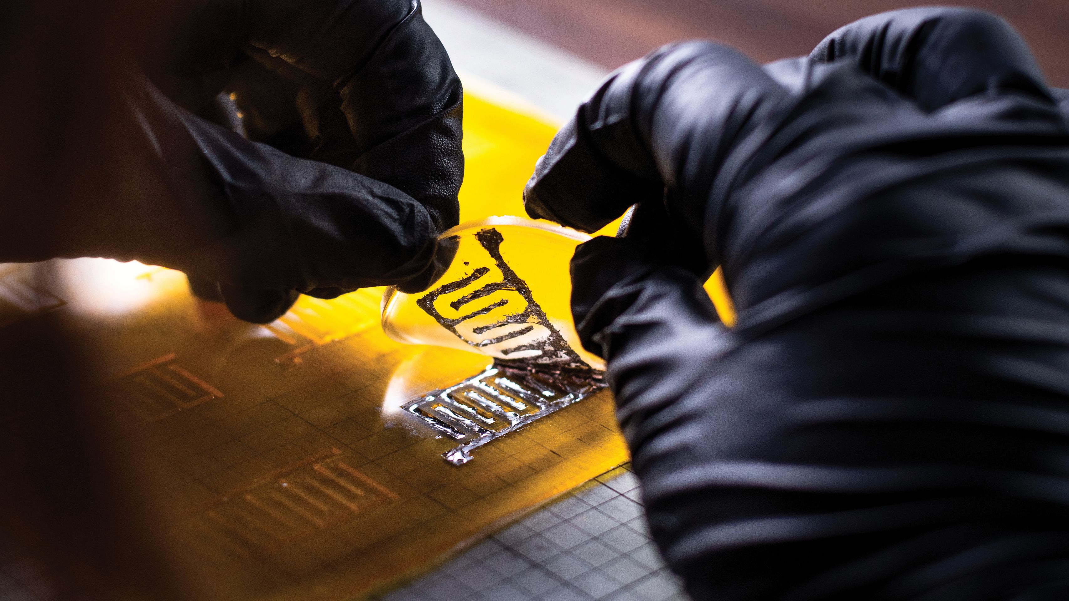 Bury peels the finished electrode disk from the printing plate.