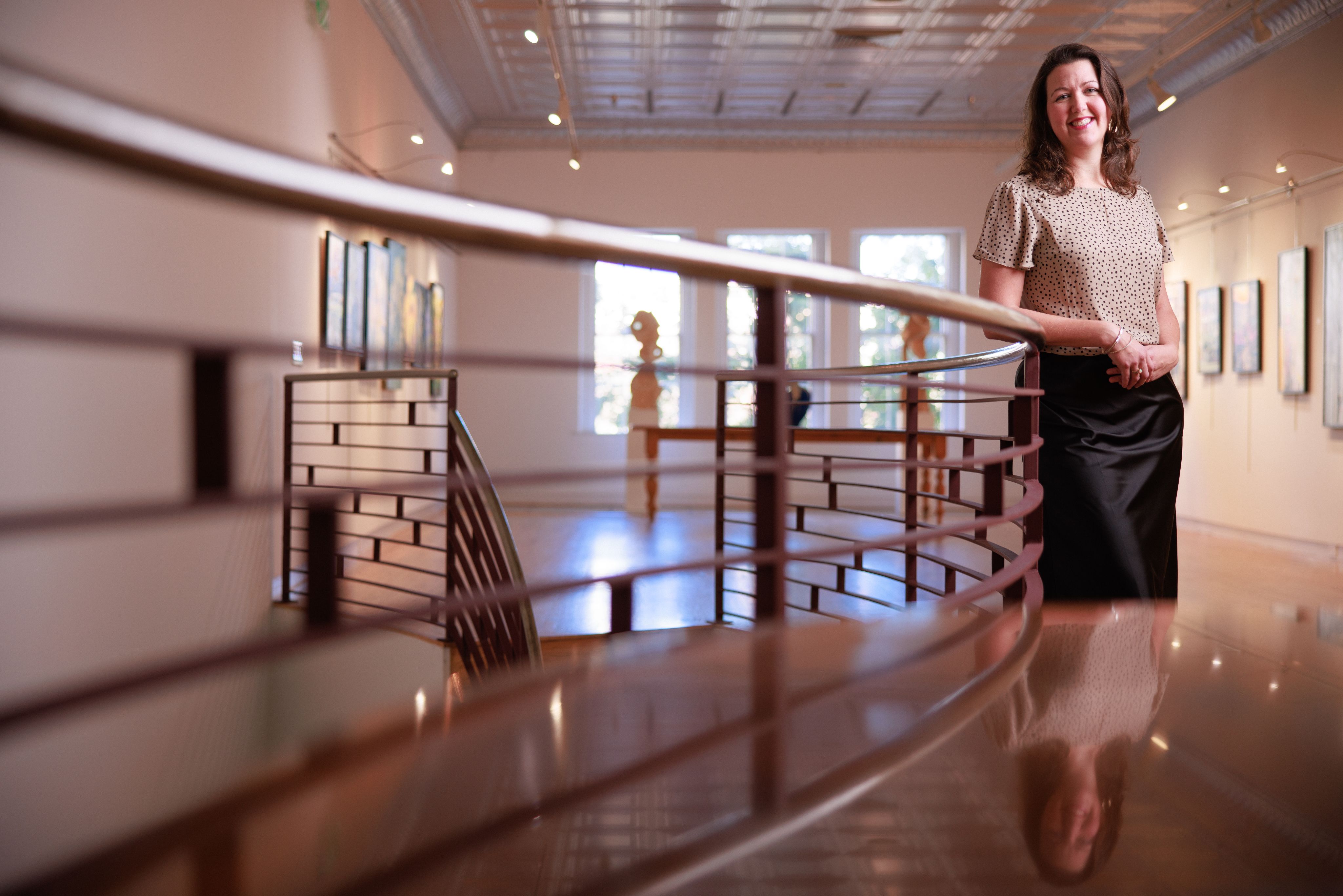 Dr. Brooke McKeever stands in art gallery