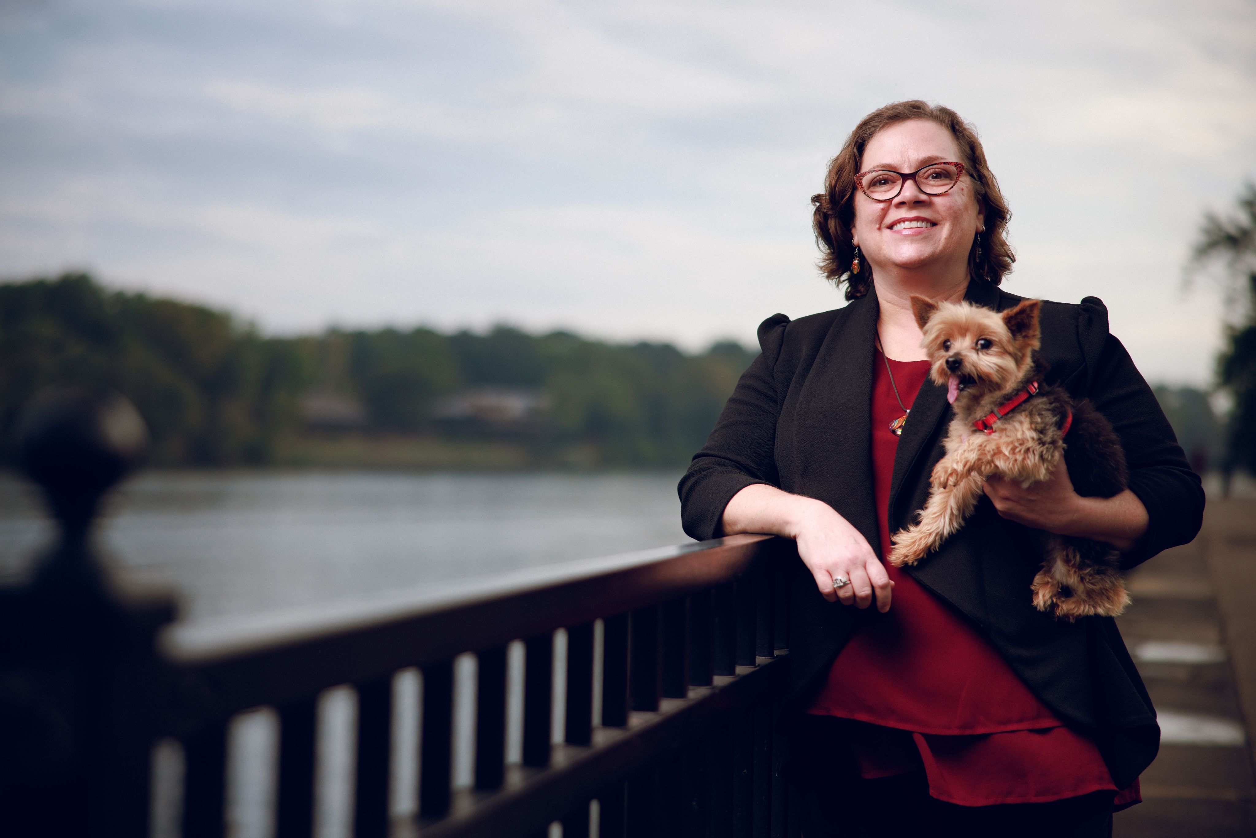 Dr. J. Suzanne Horsley stands with her dog beside the Black Warrior River