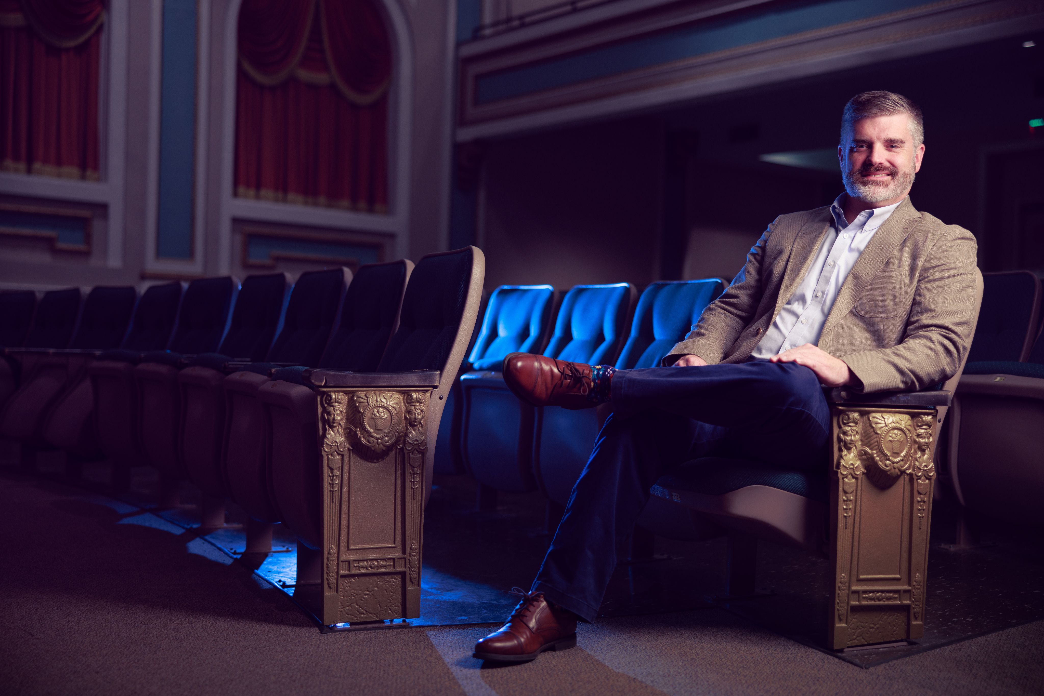 Dr. Steven Yates sits in theatre seats