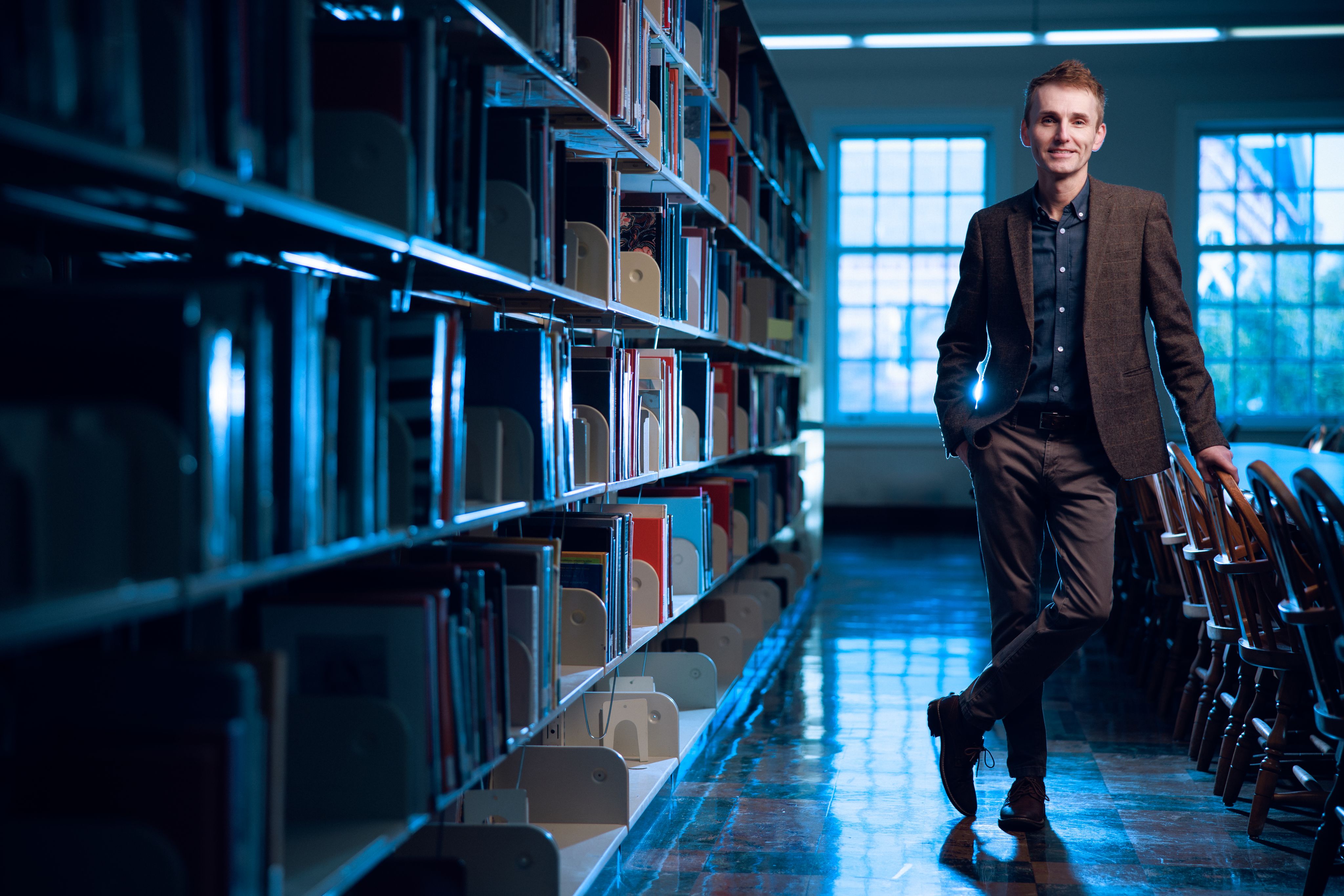 Dr. Jamie Naidoo stands in the library