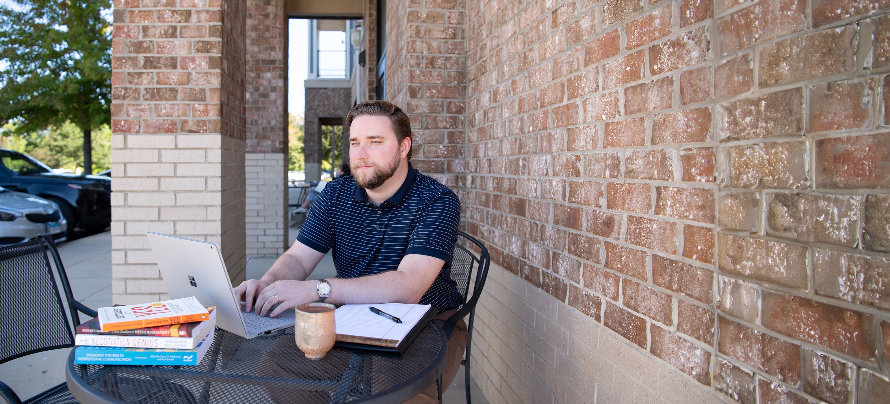 A Communications MA student works at a coffee shop